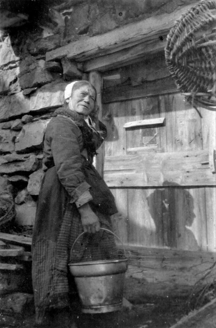 [Mme Lance portant un seau à traire, 1917, hameau des Laves, Barels.]